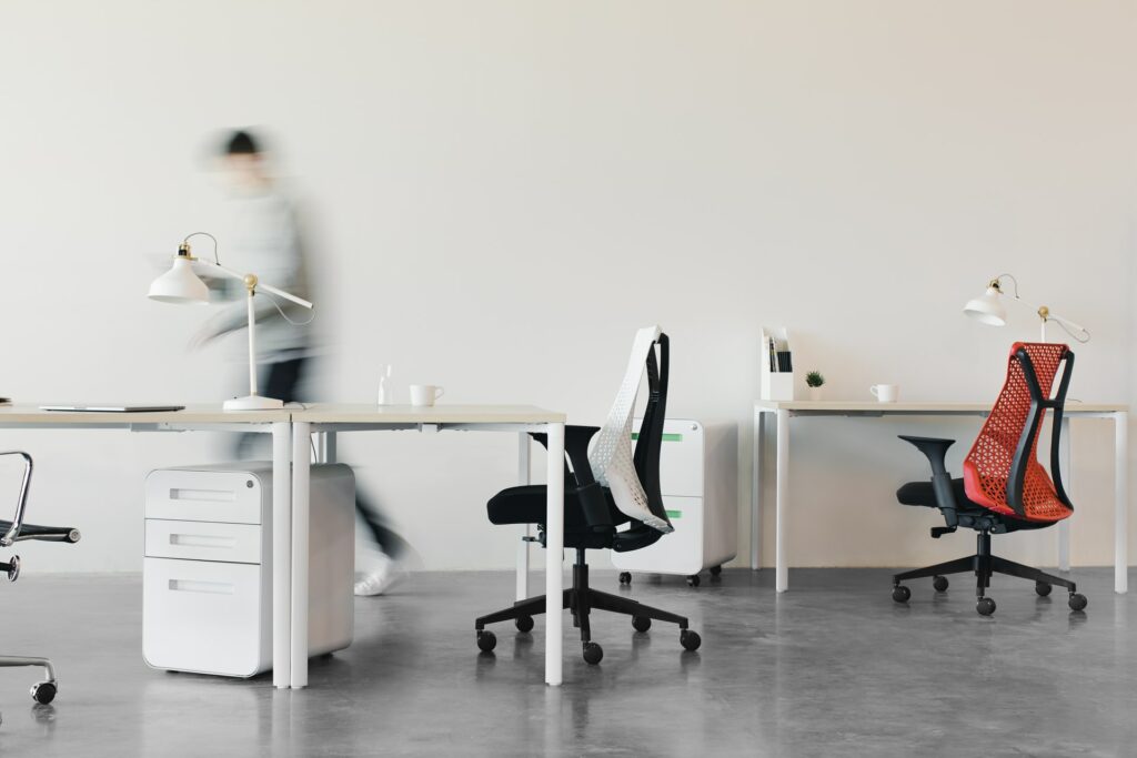 Office Chair Upgrade could be one of the two chairs on screen here, next to desks with good lumbar support.