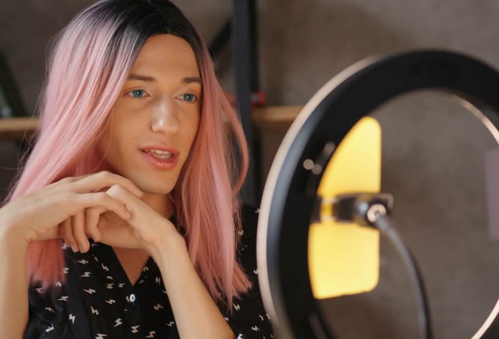 A person sit in front of a ring light which helps with video calls with XSplit VCam