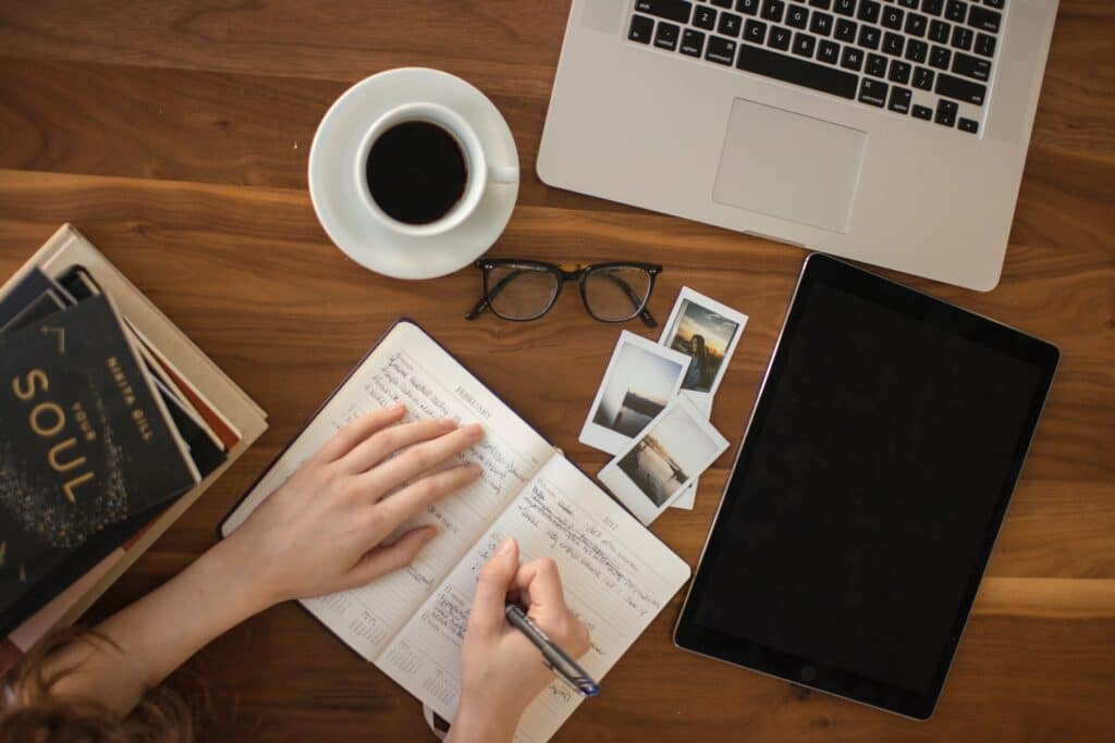 A person bullet pointing notes at a desk learning How To Write Video Tutorials